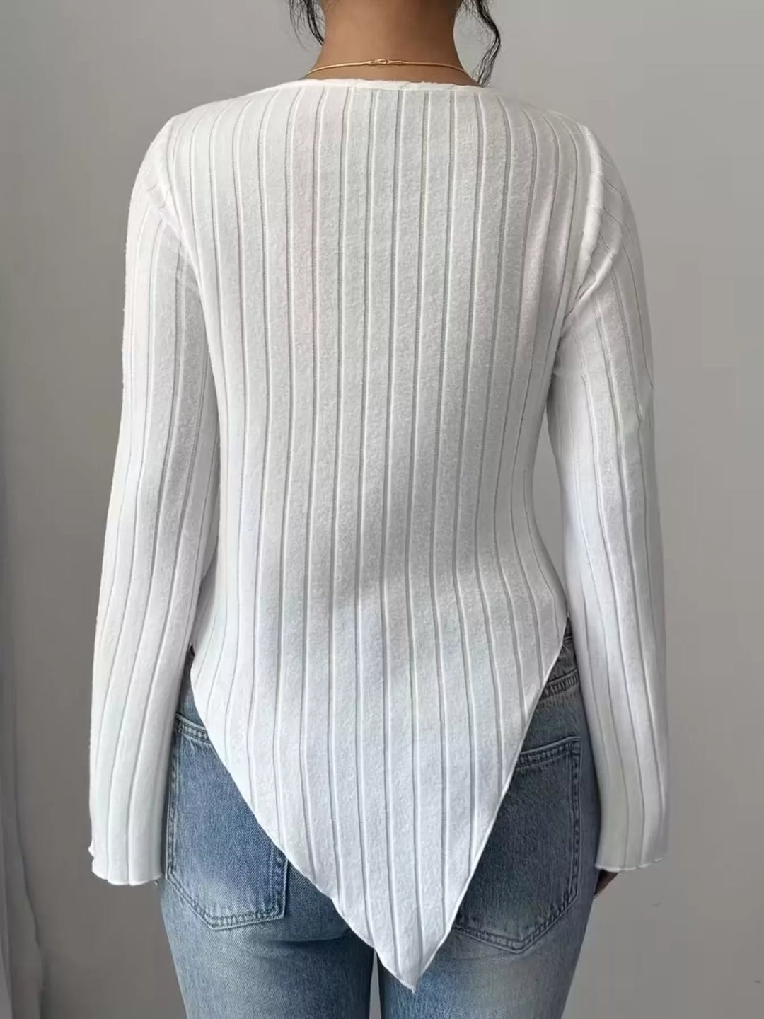 Ribbed knit top with asymmetric hem and flared sleeves