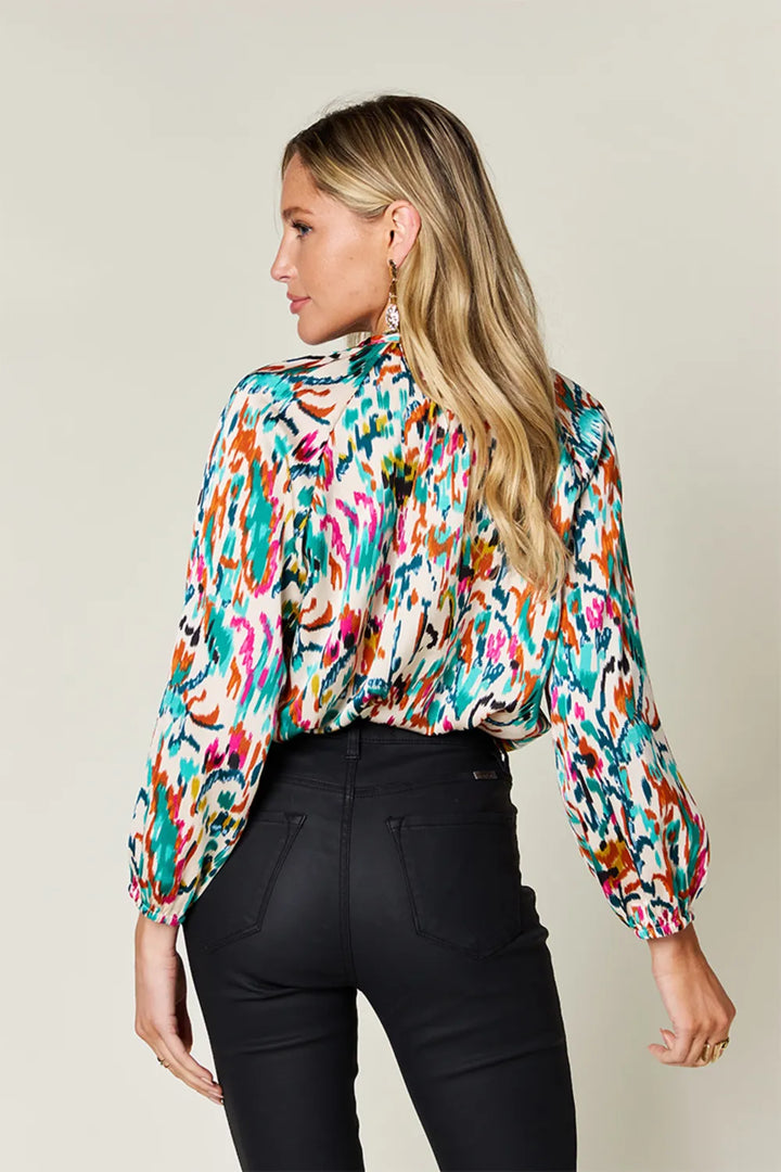 Abstract print button-up shirt with tie neck and long sleeves