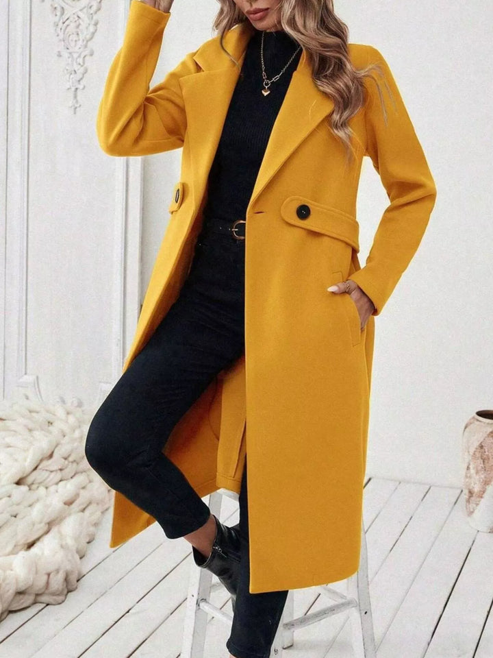 Longline notch lapel coat with single-button waist tab