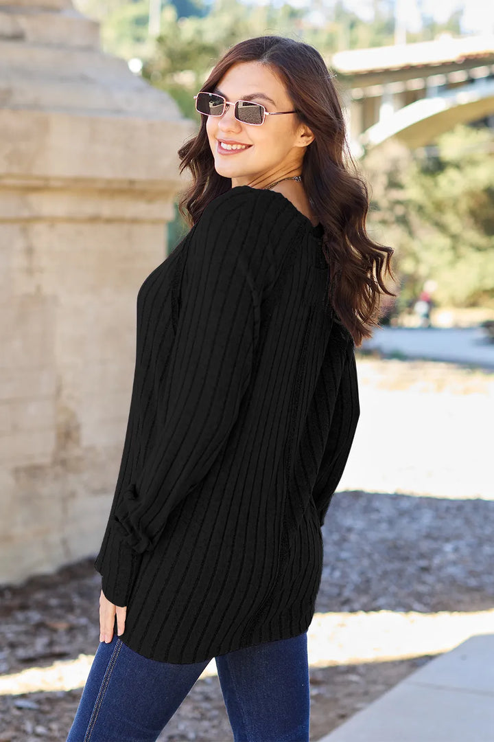Ribbed knit round neck long sleeve top with curved hem