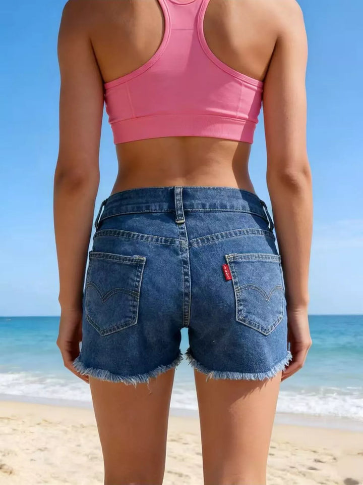 Raw hem denim shorts with frayed edges and five-pocket styling