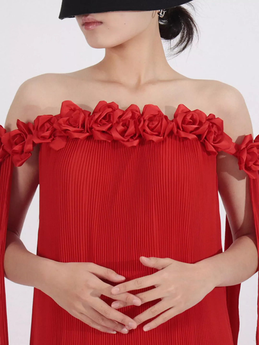 Off-shoulder pleated maxi dress with rosette neckline