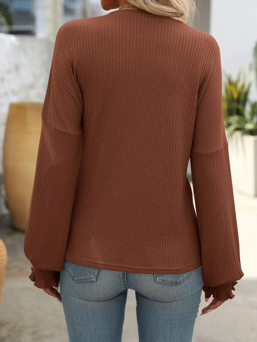 Ribbed knit crew neck top with ruffled smocked cuffs