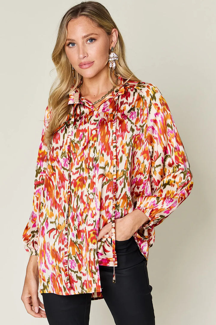 Tangerine Abstract print button-up shirt with tie neck and long sleeves