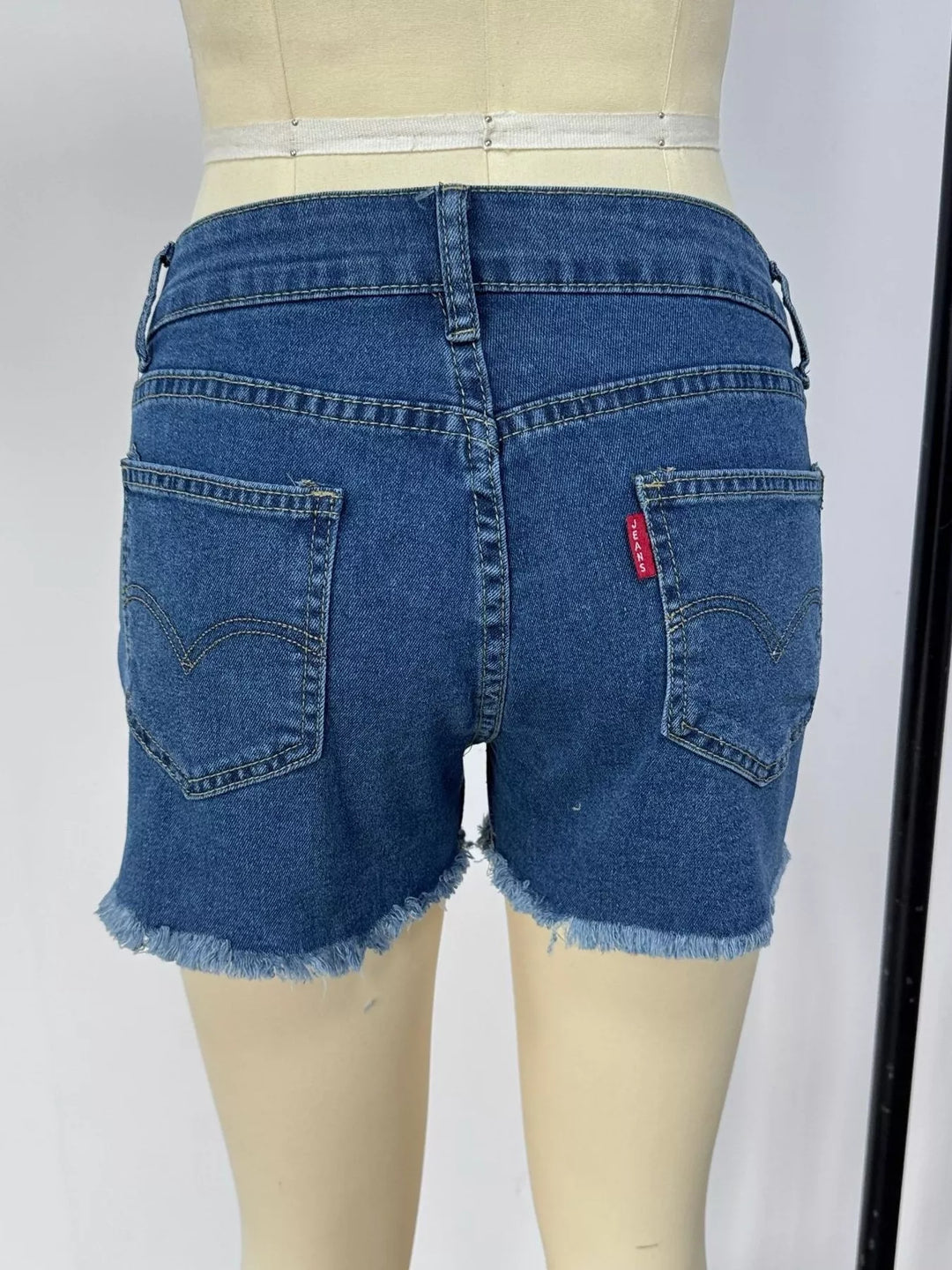 Raw hem denim shorts with frayed edges and five-pocket styling