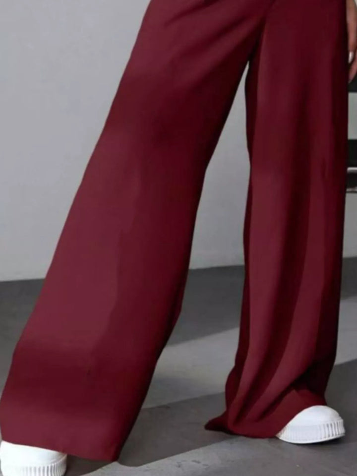 High-rise wide-leg pleated pants with button waist
