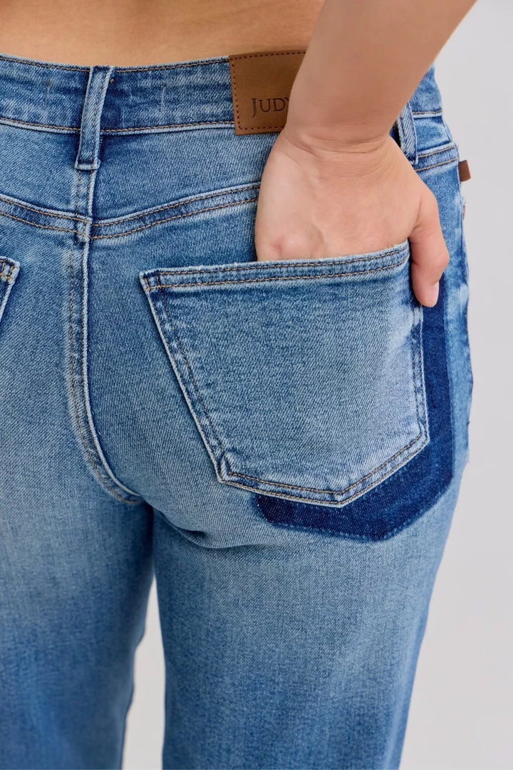 Distressed mid-rise boyfriend jeans with released raw hem