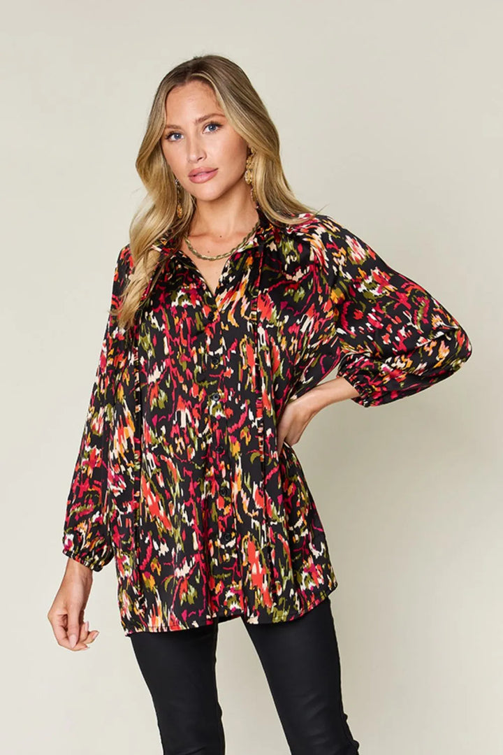 Abstract print button-up shirt with tie neck and long sleeves
