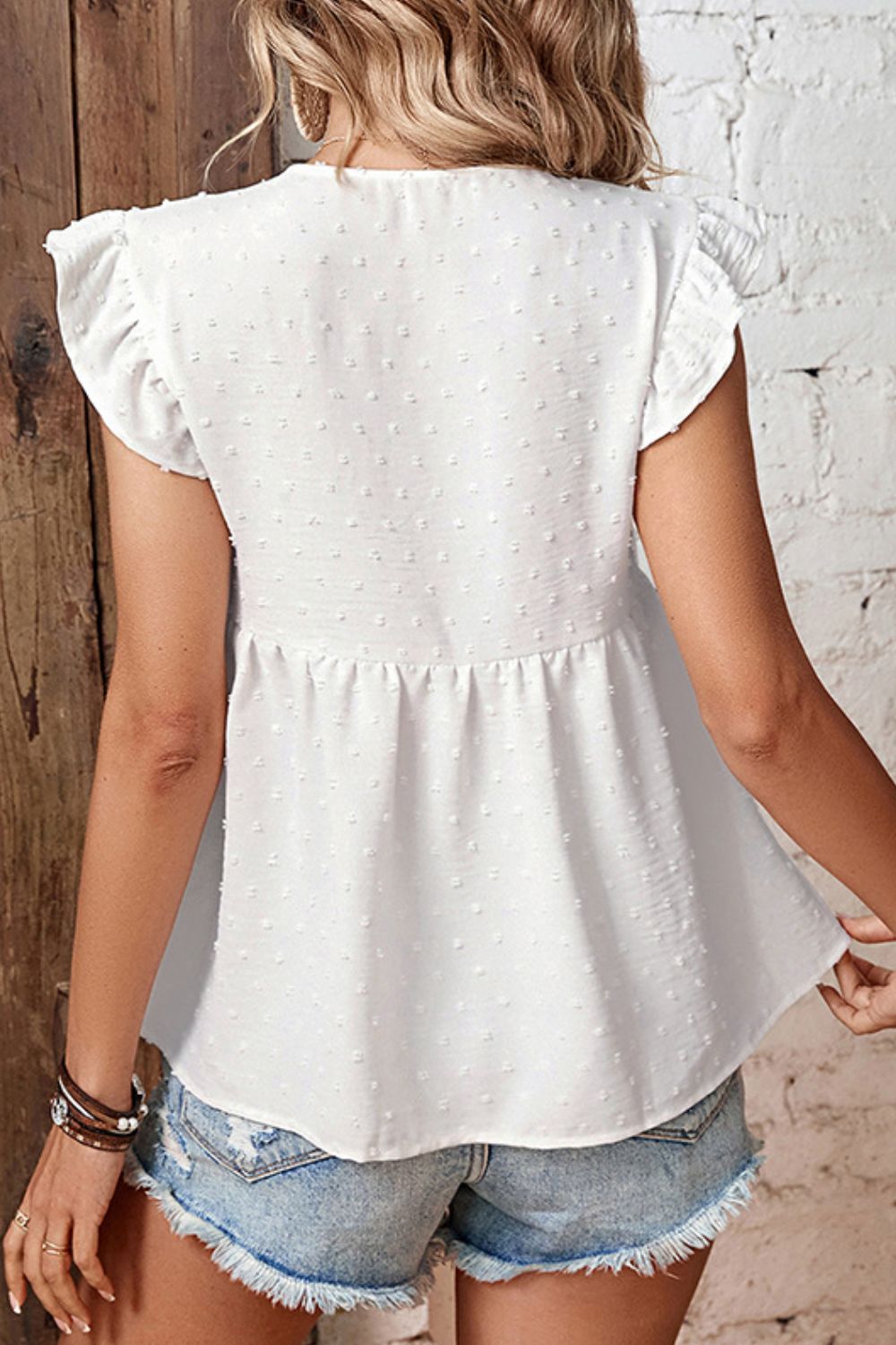 Swiss dot flutter sleeve peplum blouse with tie neck