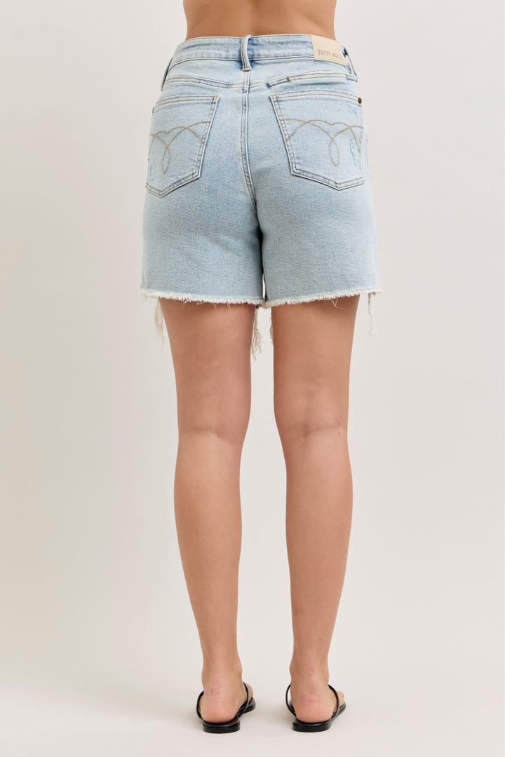 Distressed high-rise denim shorts with raw frayed hem