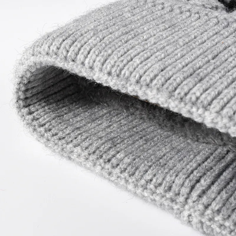 Striped scallop knit beanie with faux fur pom-pom