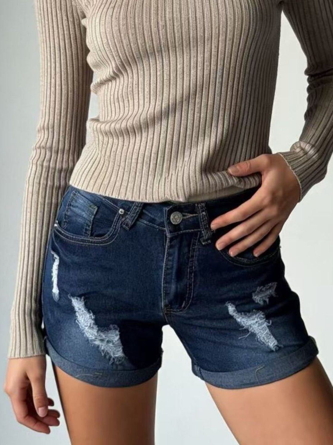 Distressed mid-rise denim shorts with cuffed hem
