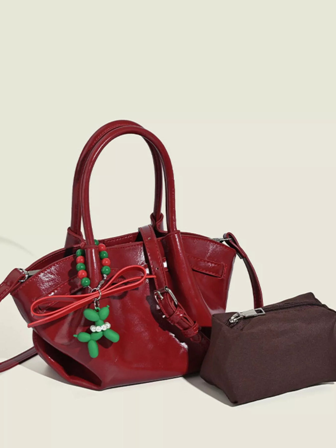 Glossy slouchy top handle crossbody bag with beaded charm