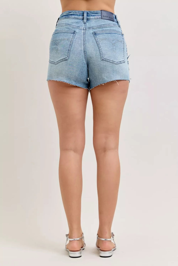 High-rise rigid denim cutoff shorts with raw frayed hem