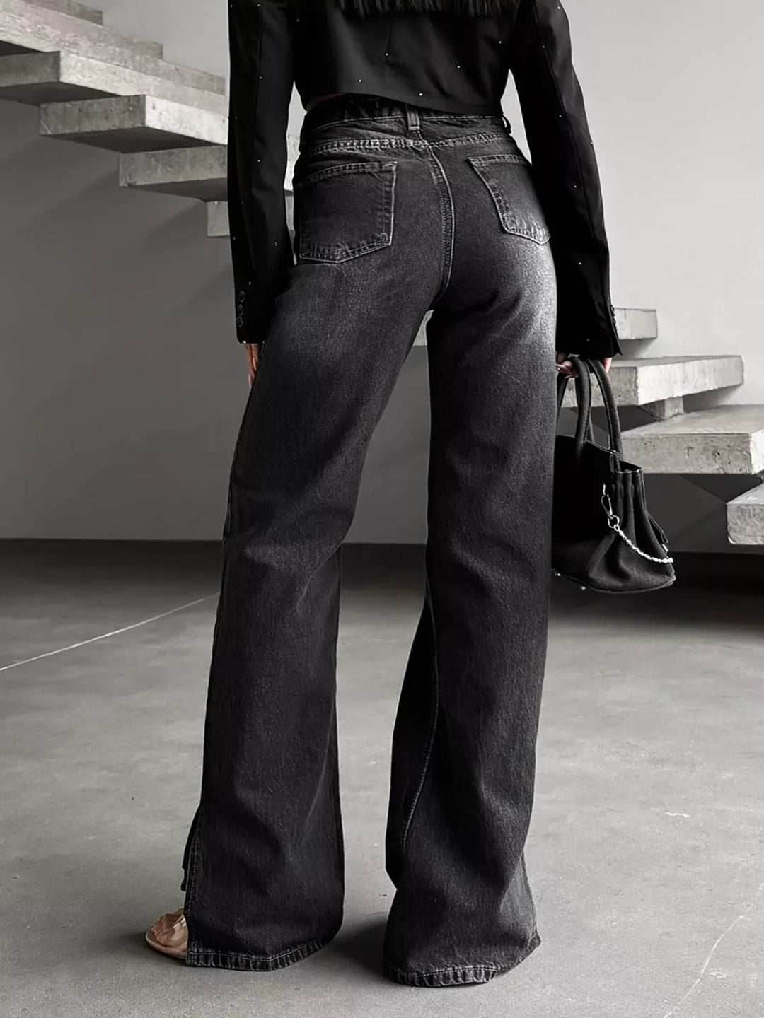 High-rise wide-leg jeans with crossover waistband and slit hem