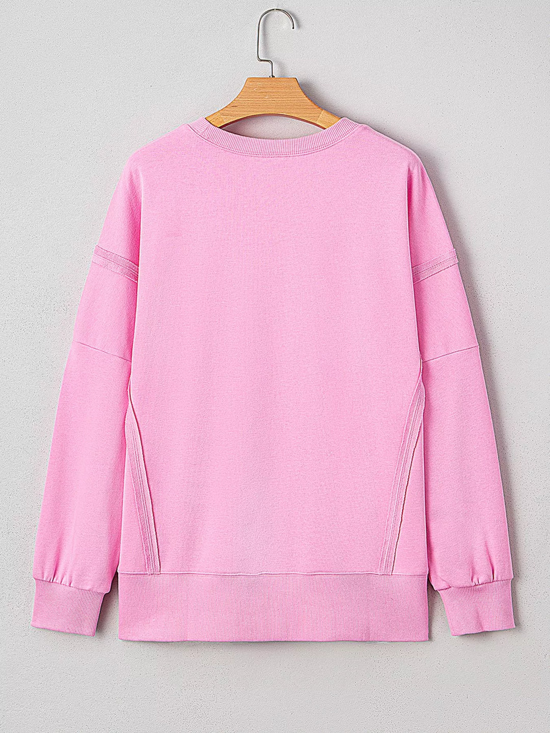 Oversized XOXO graphic sweatshirt with exposed seams and bows