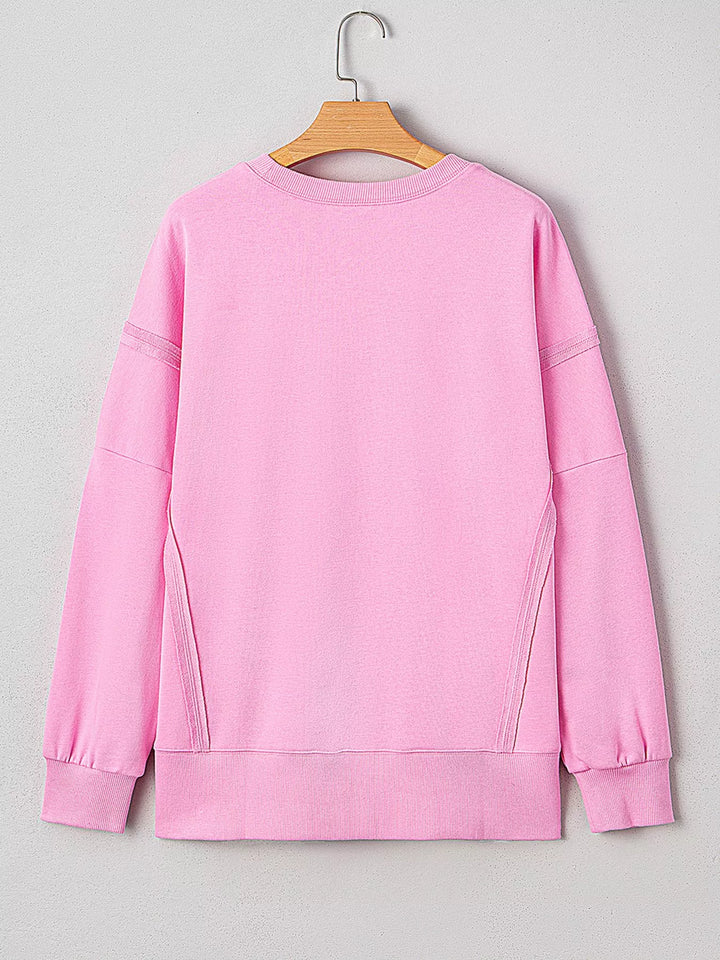 Oversized XOXO graphic sweatshirt with exposed seams and bows