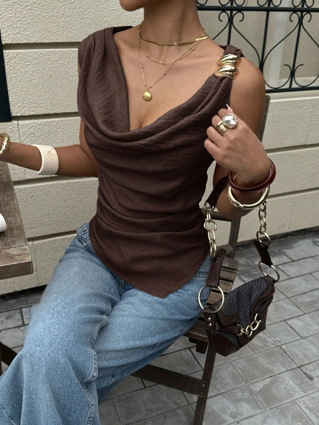 Draped cowl neck sleeveless top with asymmetrical hem