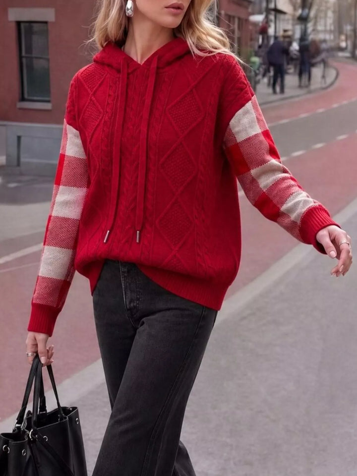 Cable knit hooded sweater with plaid sleeves and drawstring
