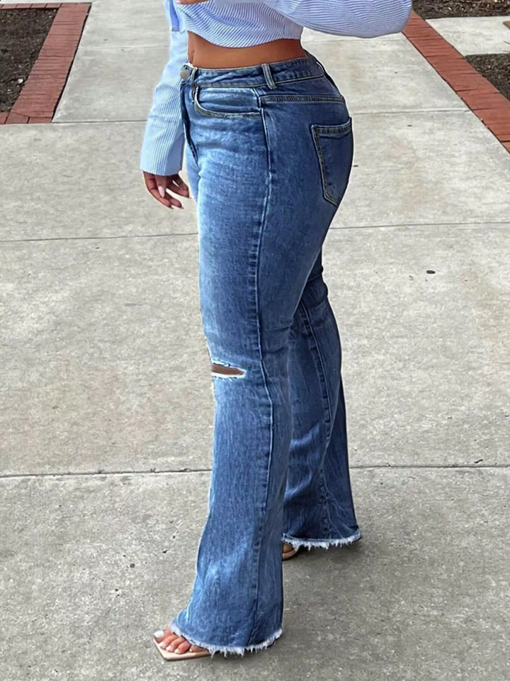 High-rise ripped knee flare jeans with raw hem