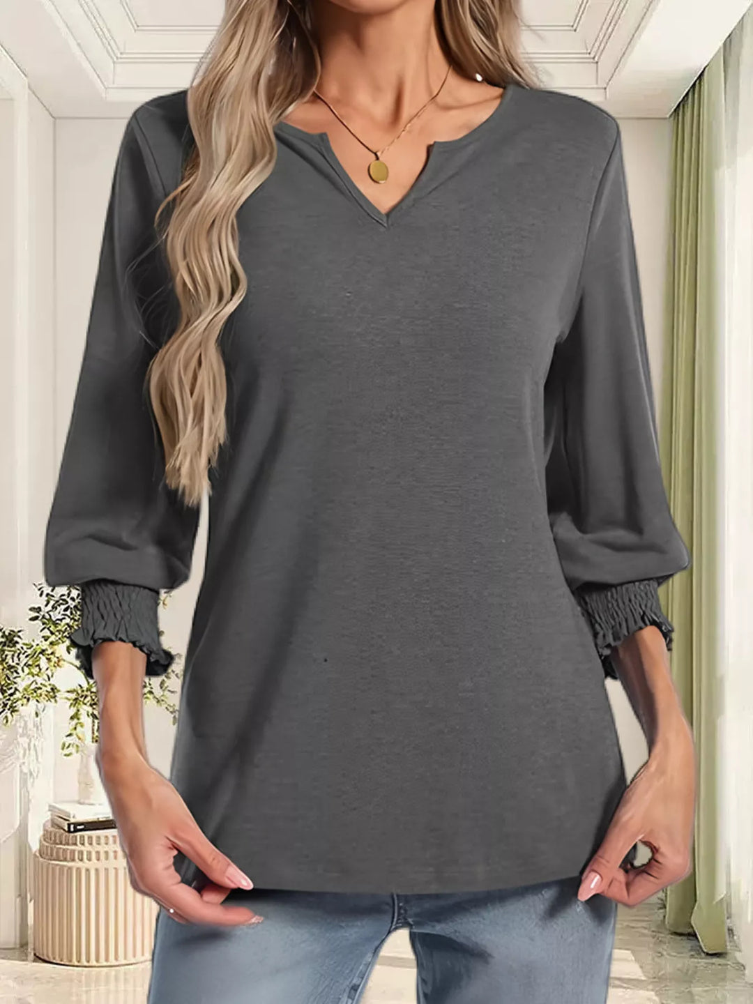 Notched V-neck three-quarter sleeve top with smocked cuffs