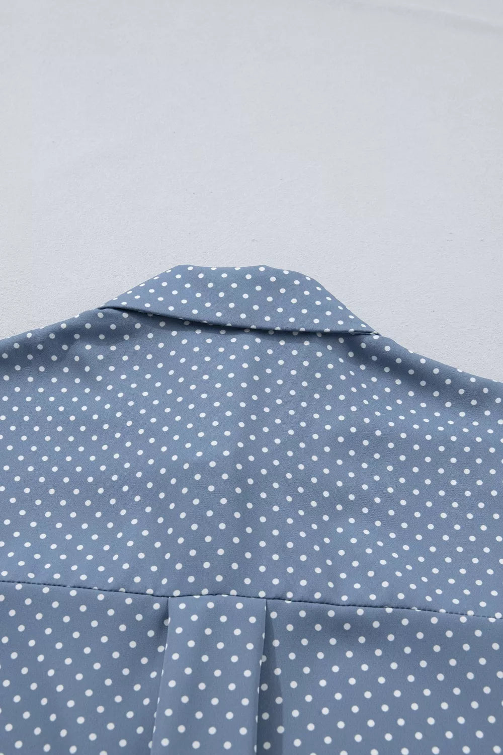 Polka dot button-down shirt with cuffed short sleeves