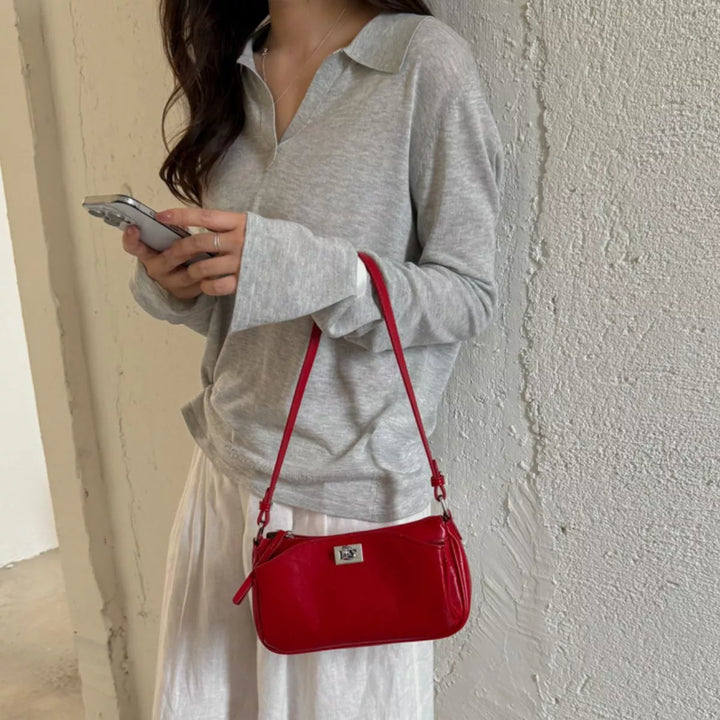 Faux leather baguette shoulder bag with twist lock