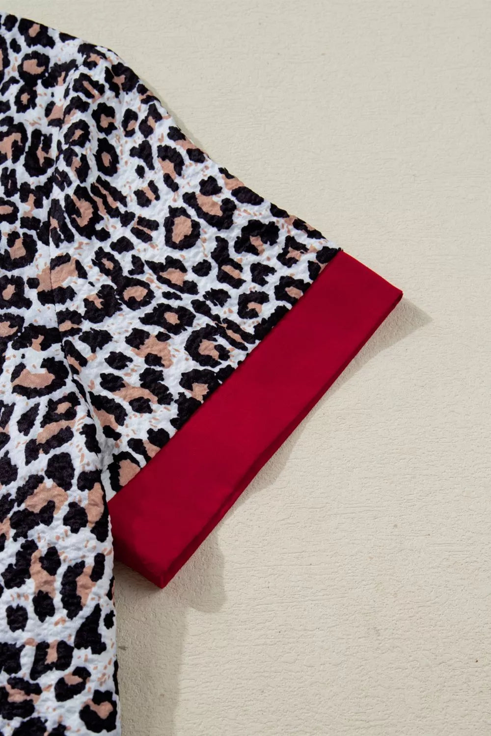 Leopard print short sleeve button-down with contrast ruffle trim