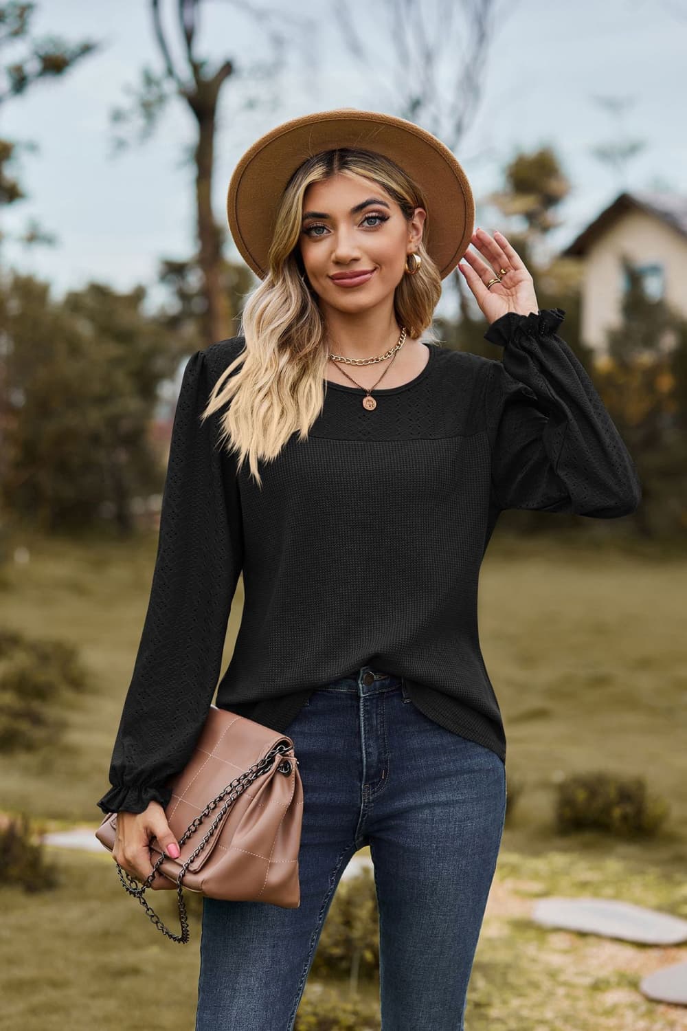 Black Eyelet knit puff sleeve blouse with round neckline