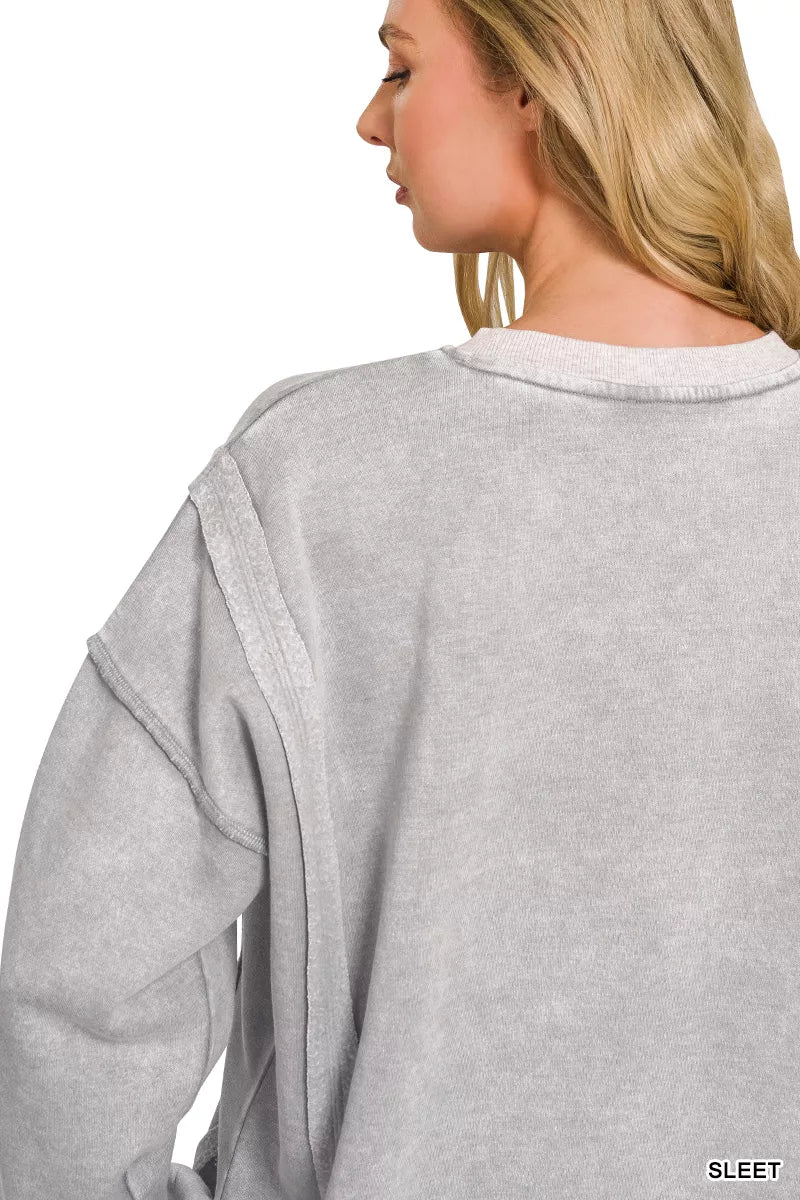 Acid wash fleece pullover with exposed seams and side slits