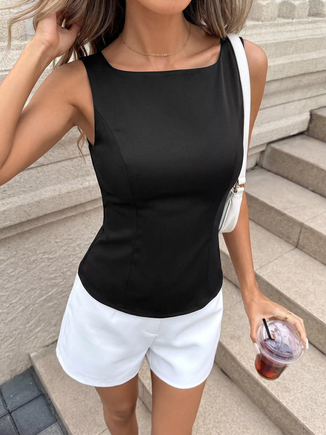 Sleeveless fitted top with cutout back and bow