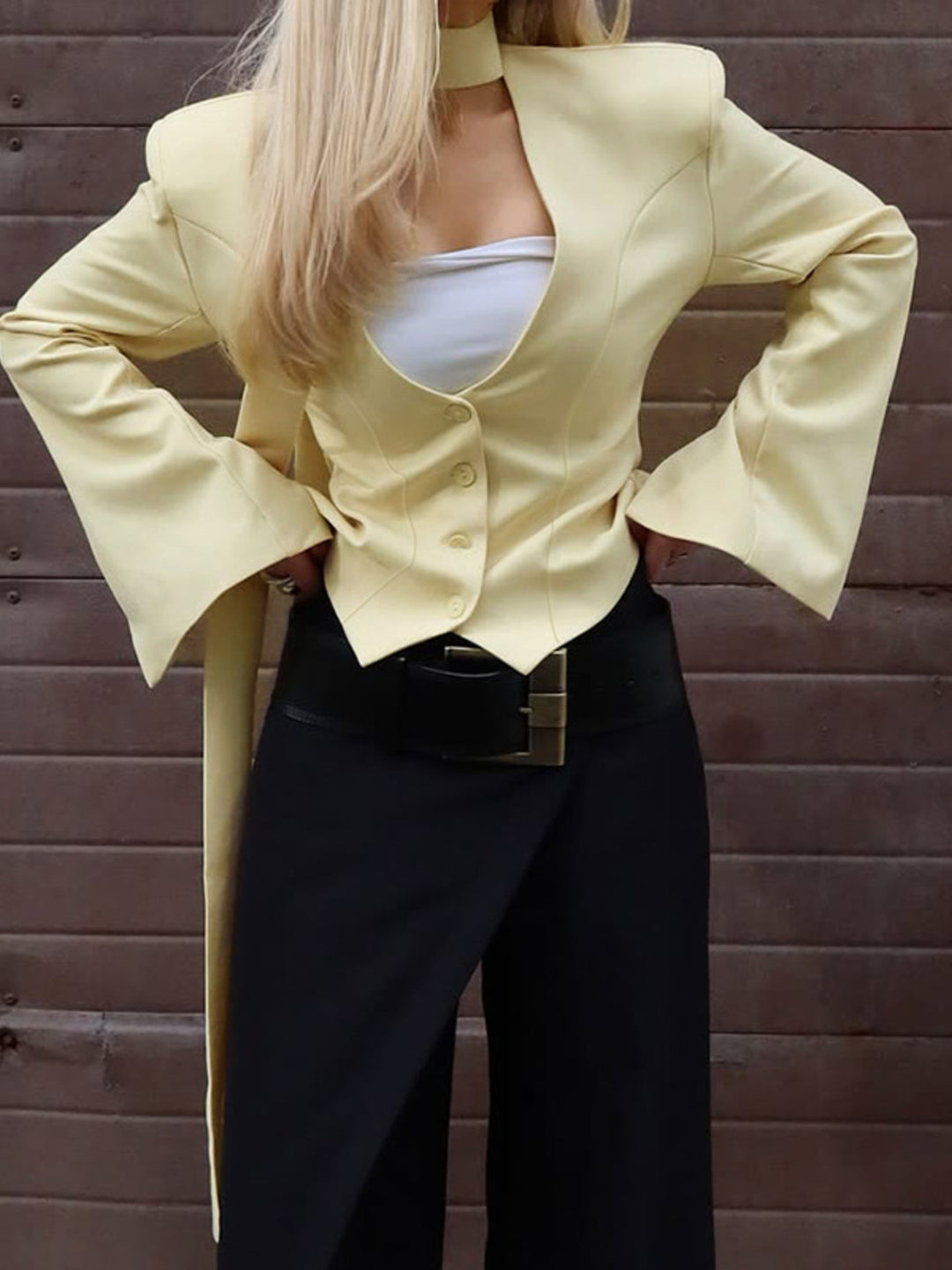 Fitted button-up blazer with tie-neck scarf and structured shoulders