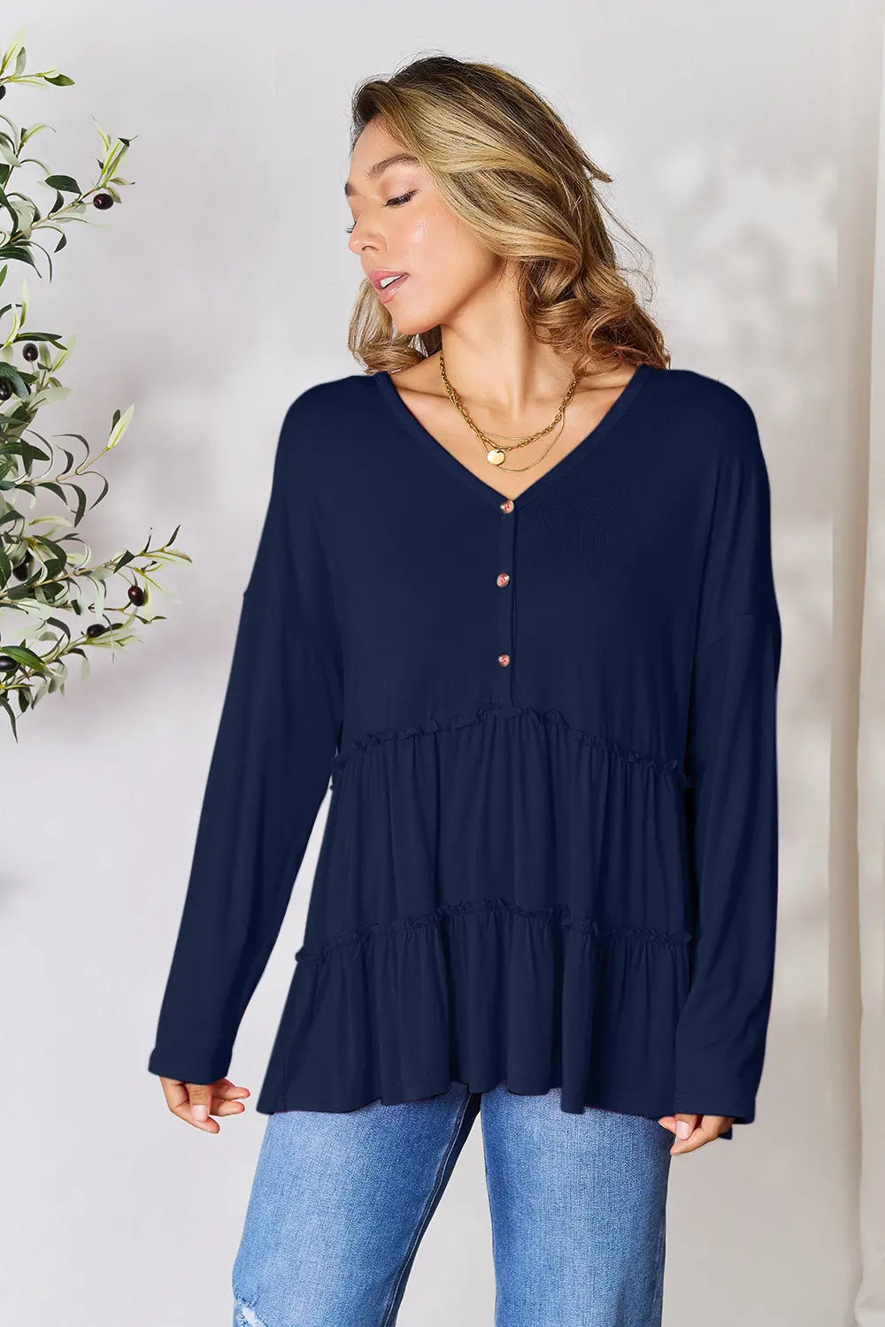 Half-button long sleeve blouse with tiered ruffle hem
