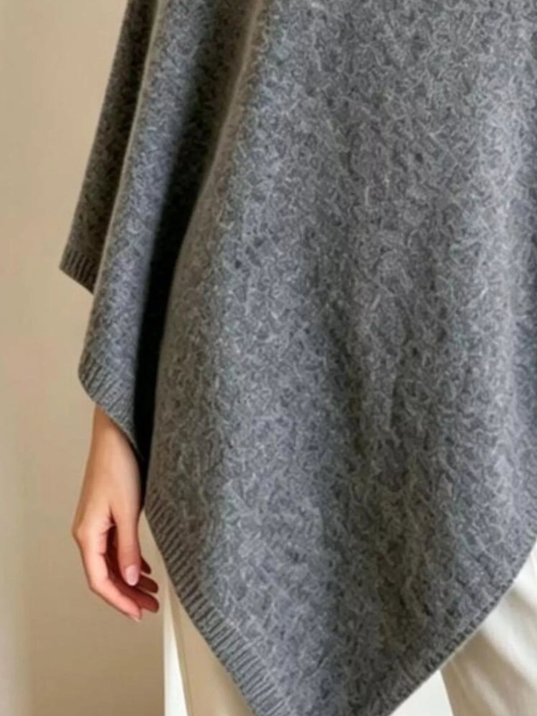 Asymmetrical hem textured knit poncho with ribbed crew neck