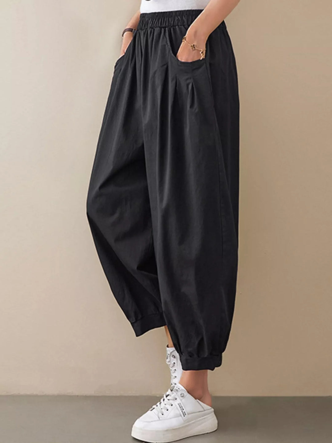 Pleated harem pants with elastic waist and tapered cuffs