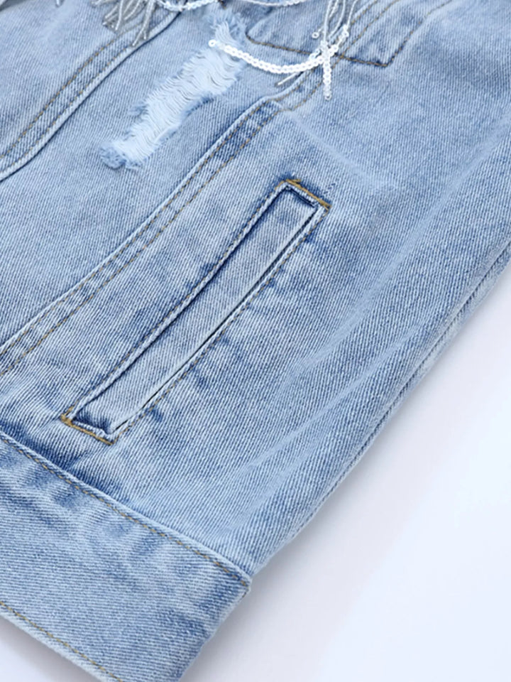 Distressed denim jacket with sequin fringe and chest pockets