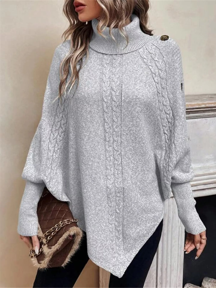 Cable knit turtleneck cape sweater with button shoulder