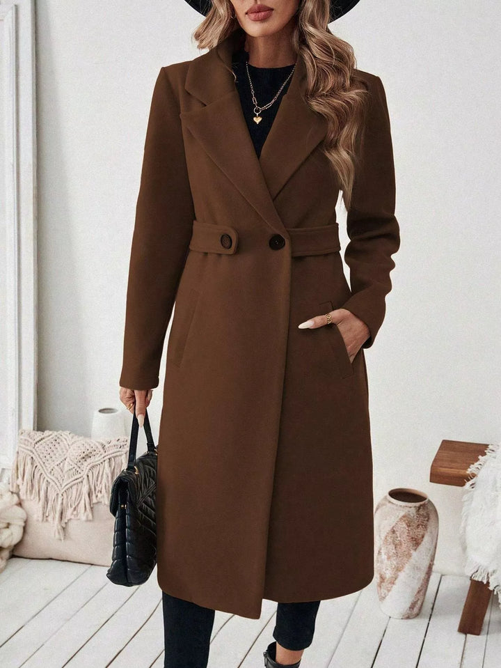 Longline notch lapel coat with single-button waist tab