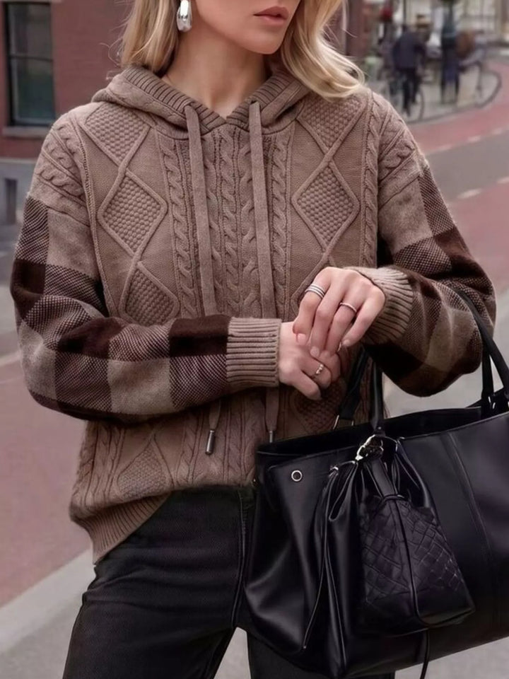 Cable knit hooded sweater with plaid sleeves and drawstring