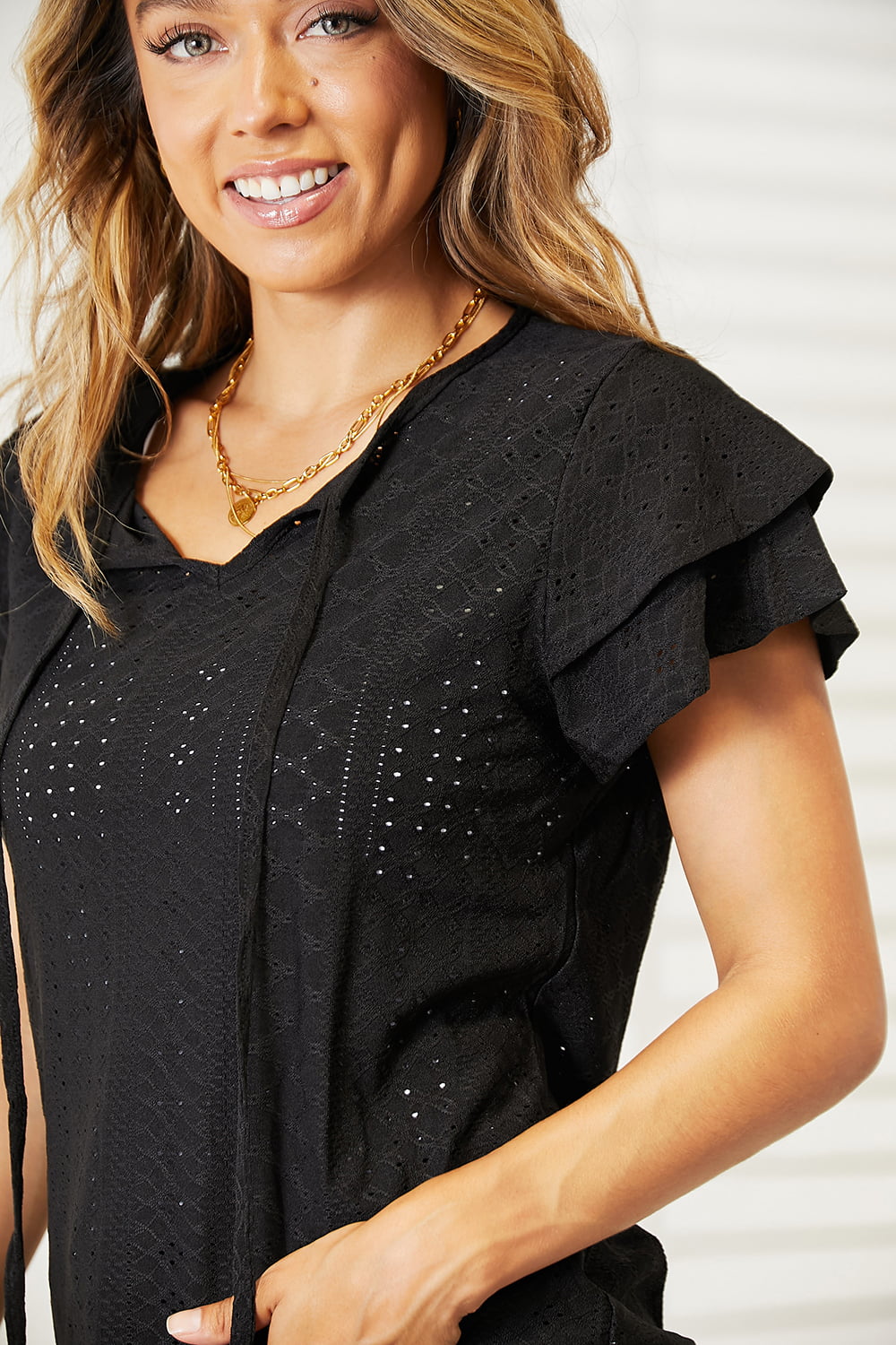 Eyelet tie-neck blouse with tiered flutter sleeves