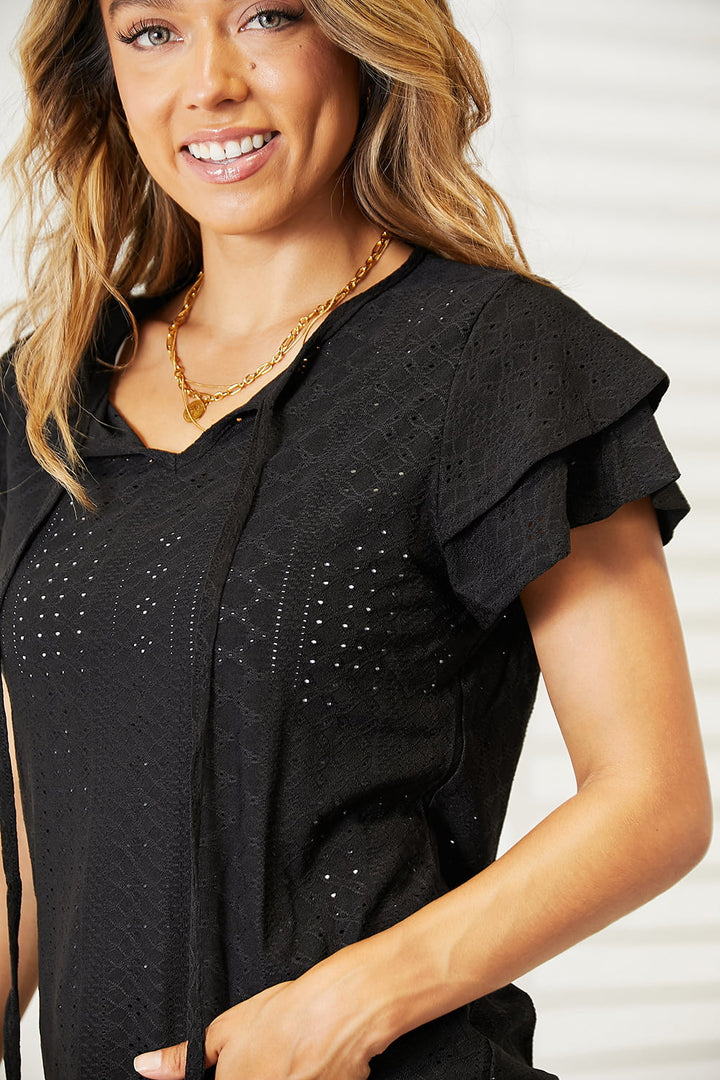 Eyelet tie-neck blouse with tiered flutter sleeves