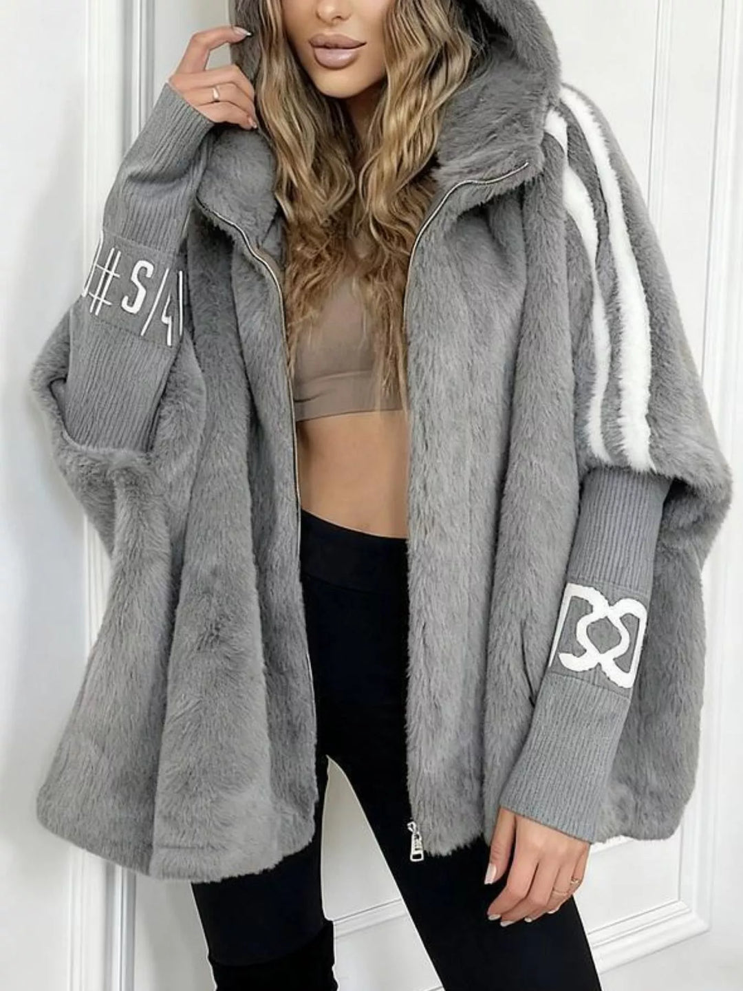 Hooded faux fur coat with striped trim and knit sleeves