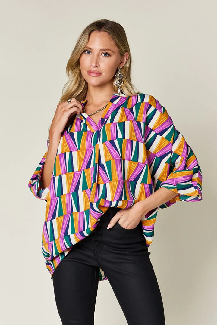 Geometric print notched neck dolman sleeve top