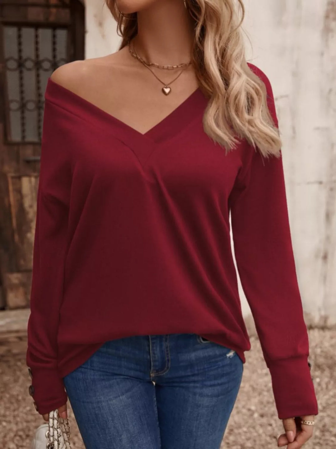 Burgundy V-neck long sleeve top with button cuffs