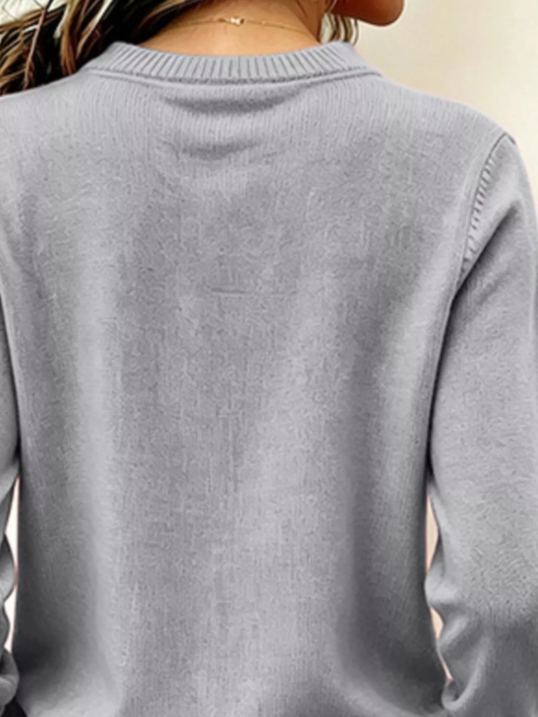 V-neck long sleeve sweater with button cuffs and side slits