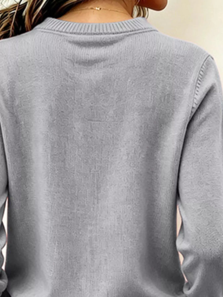 V-neck long sleeve sweater with button cuffs and side slits