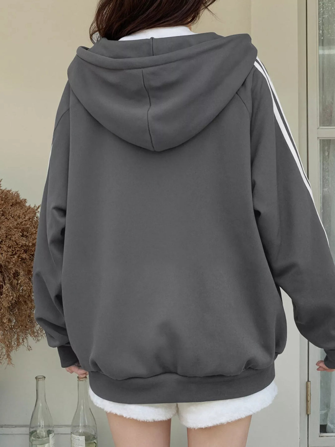 Oversized zip-up hoodie with striped sleeves and drawstring hood