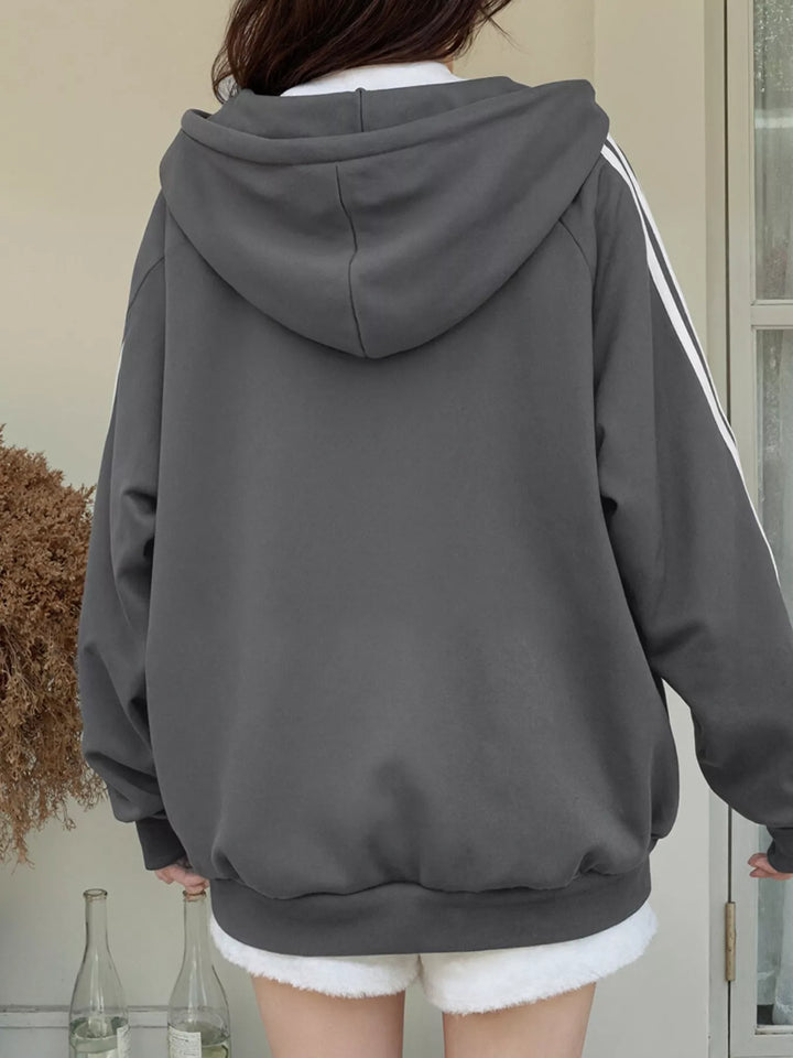 Oversized zip-up hoodie with striped sleeves and drawstring hood