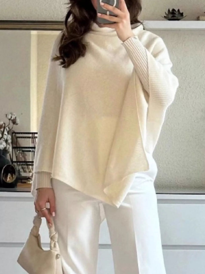 Turtleneck poncho sweater with asymmetric hem and batwing sleeves