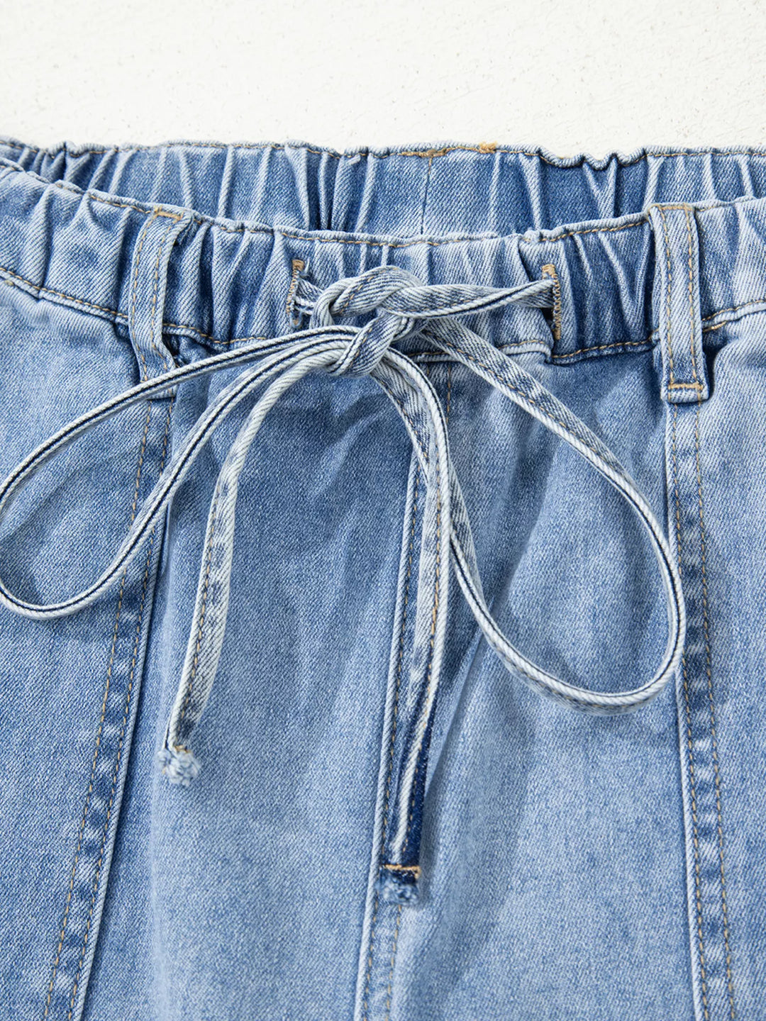 Wide-leg drawstring jeans with raw frayed hem